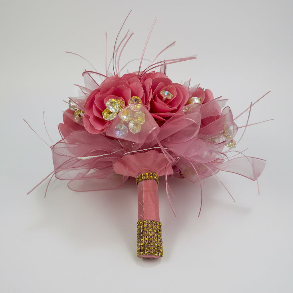 Pink flower bouquet with gold accents on a white background