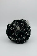 dark green  flower arrangement with silver embellishments on a white background