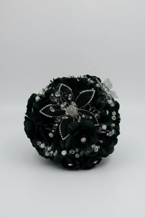 dark green  flower arrangement with silver embellishments on a white background