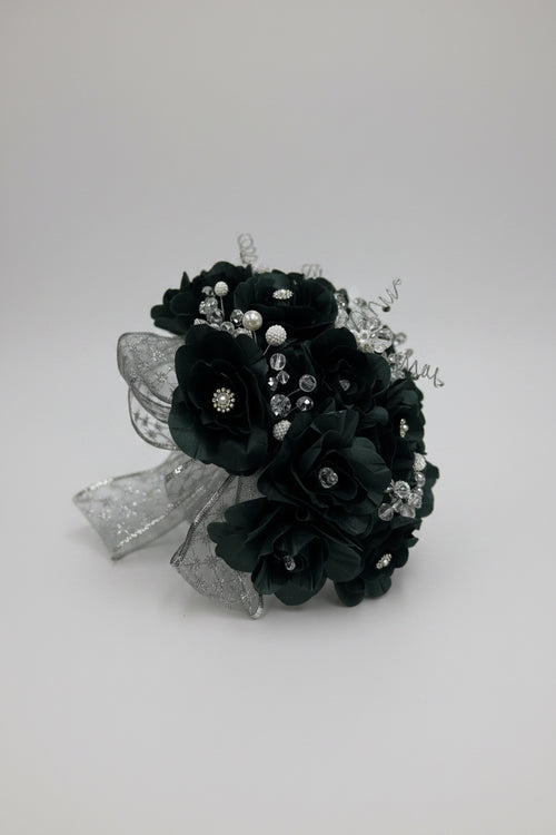 Dark green  flower bouquet with silver embellishments on a white background
