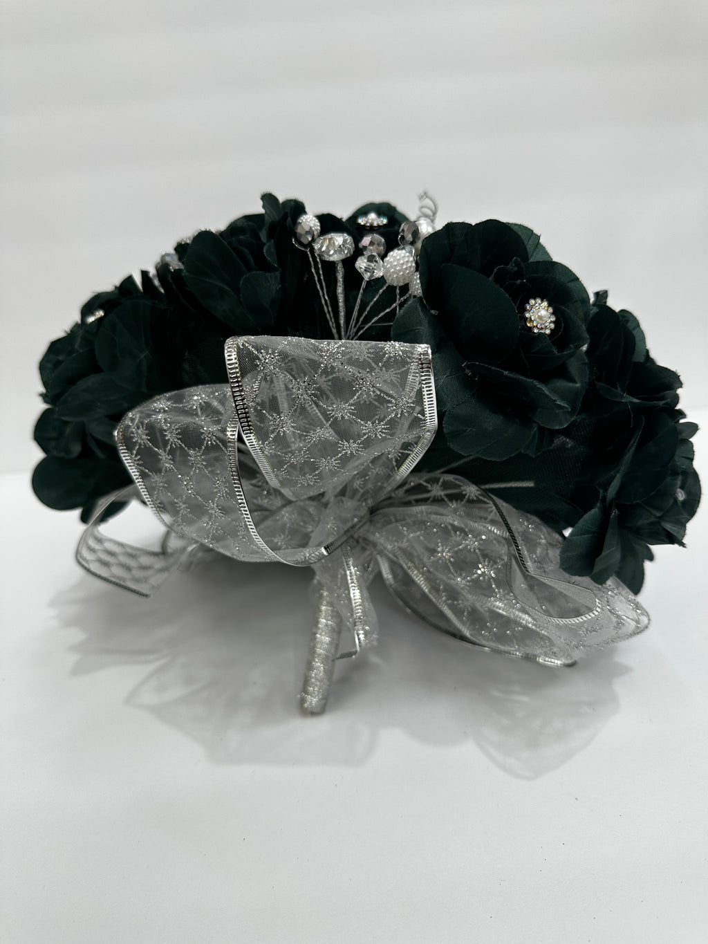 dark green  bouquet  with a decorative silver bow on the bottom on a white background