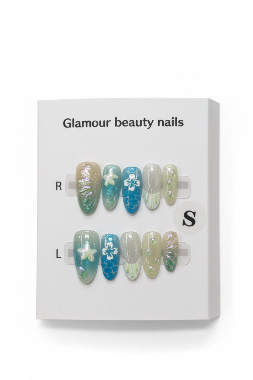 A set of decorative press-on nails displayed on a white card labeled 'Glamour beauty nails' with size markers R and S, photographed against a soft pink background.