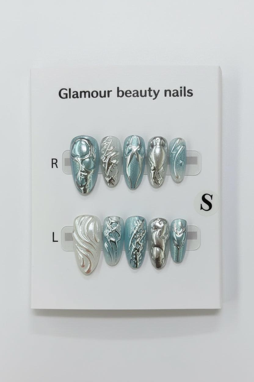 A set of false press-on nails displayed on a white card labeled 'Glamour beauty nails' with size markers R and S, photographed against a soft pink background.